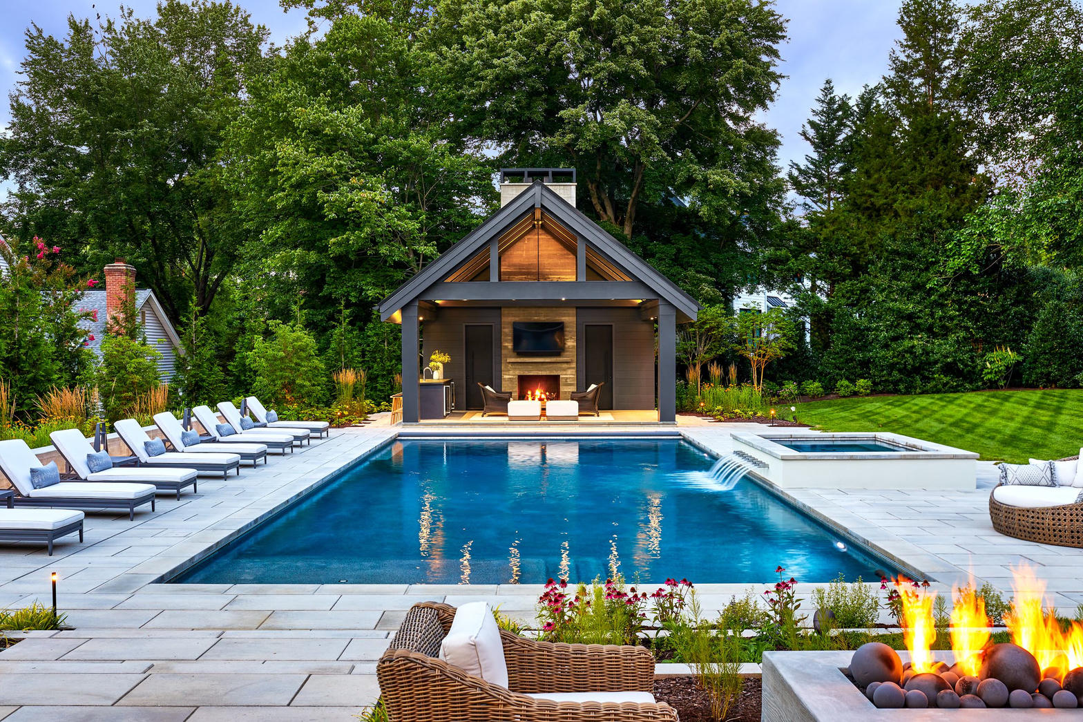 Pool house with spa and wellness area at dusk