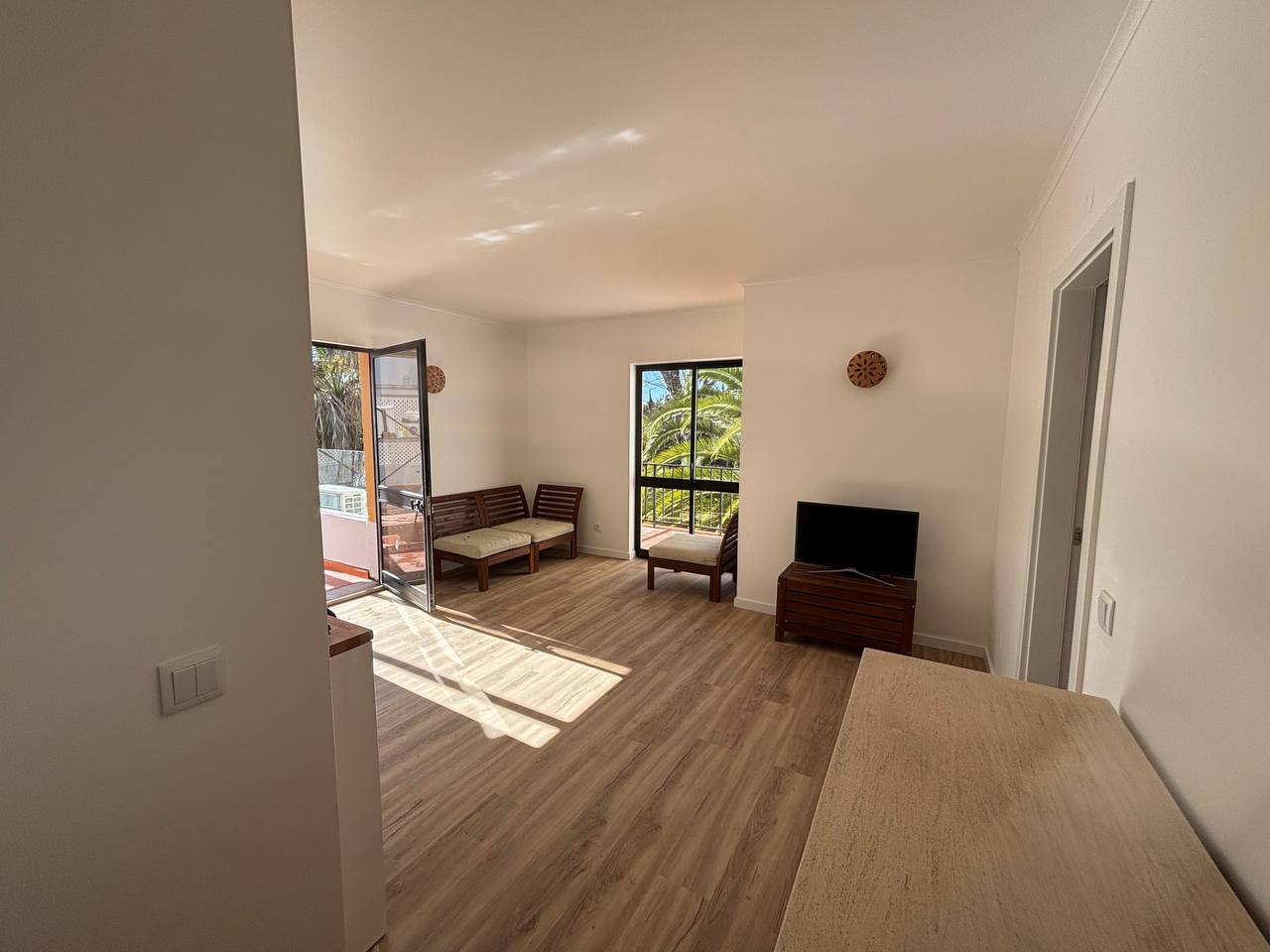 Remodeled living room with light-colored walls, ambient lighting, and stylish decorative details.