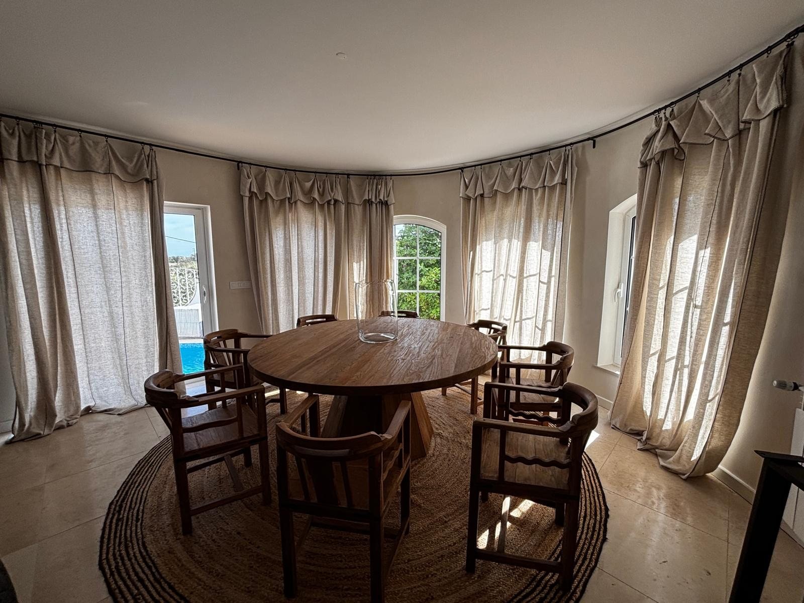 Dining room at Quinta Girassol with curved bay window and herringbone oak flooring