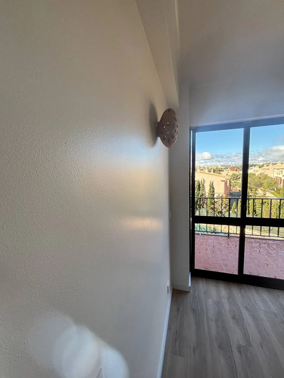 Interior view towards a glazed exterior door.